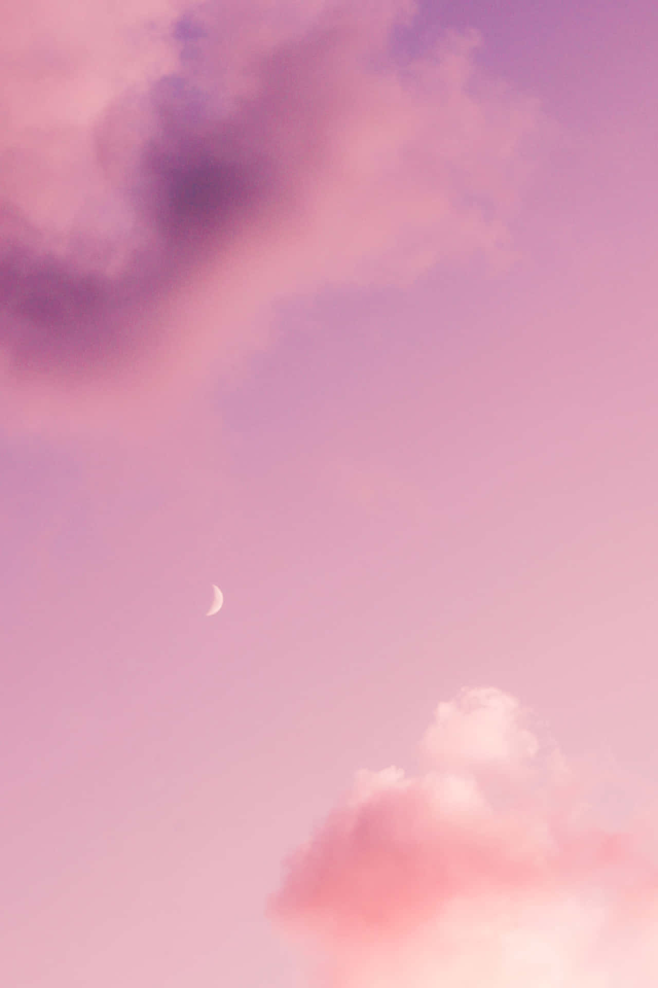 Download A Pink Sky With Clouds And A Moon | Wallpapers.com