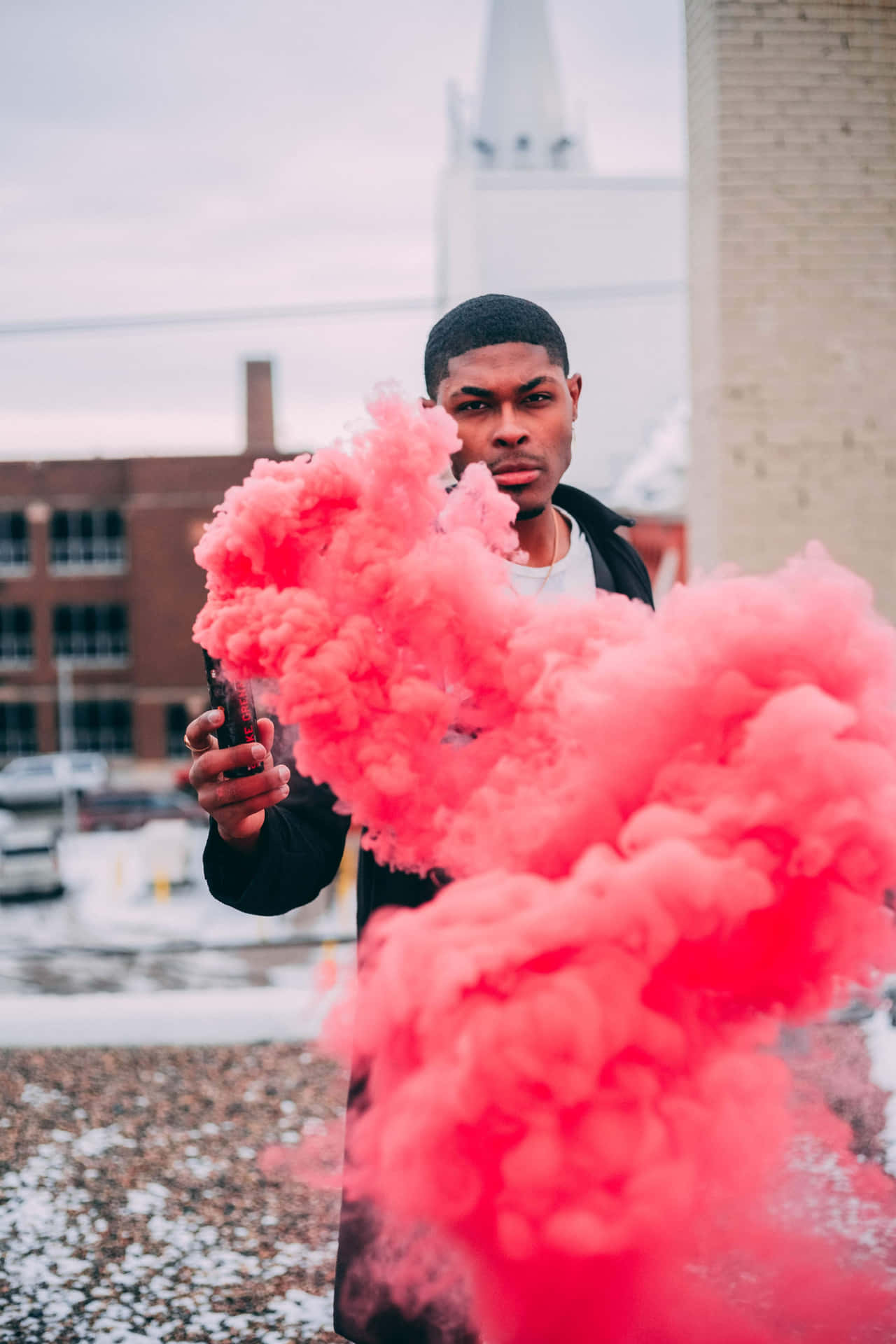 A Man Holding A Pink Smoke Bomb