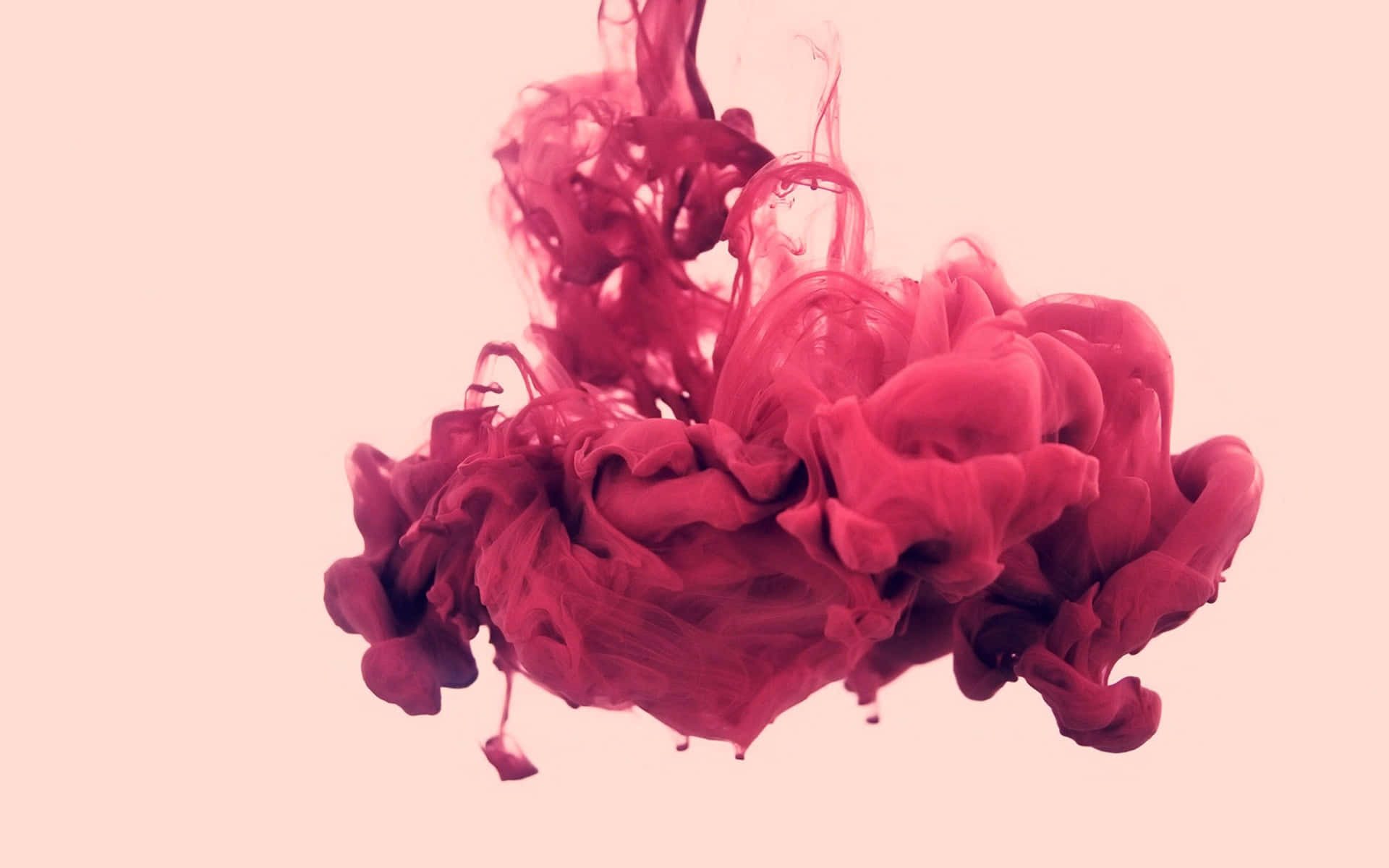 A Pink Liquid Is Poured Into A Pink Background