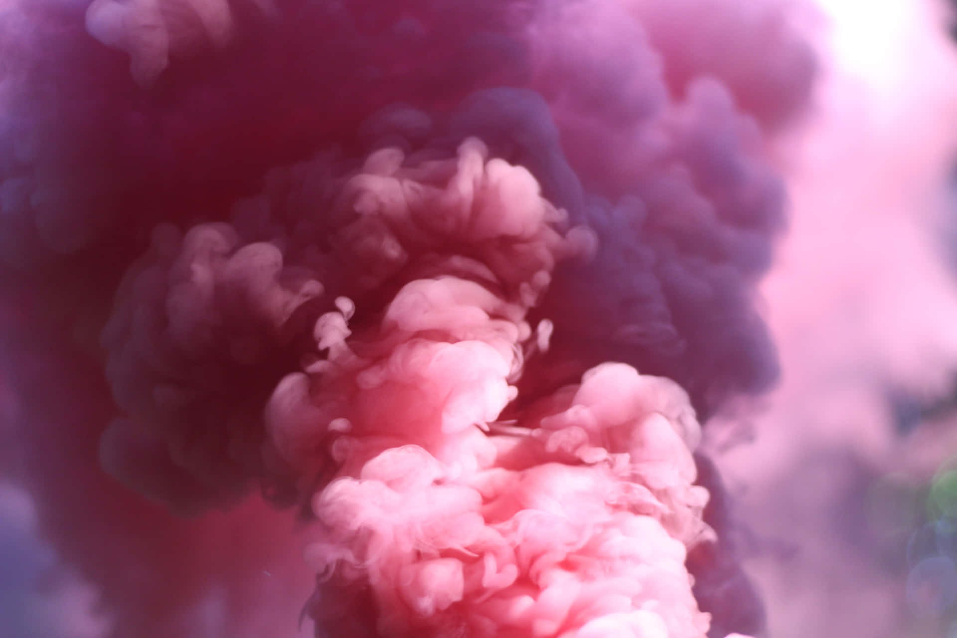 "A beautiful swirl of pink smoke hangs in the air."