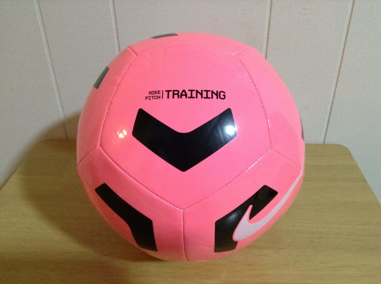 Close-up of a pink soccer ball on the field Wallpaper