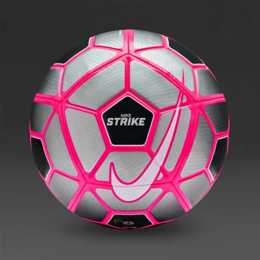 A vibrant pink soccer ball on a textured grass background Wallpaper