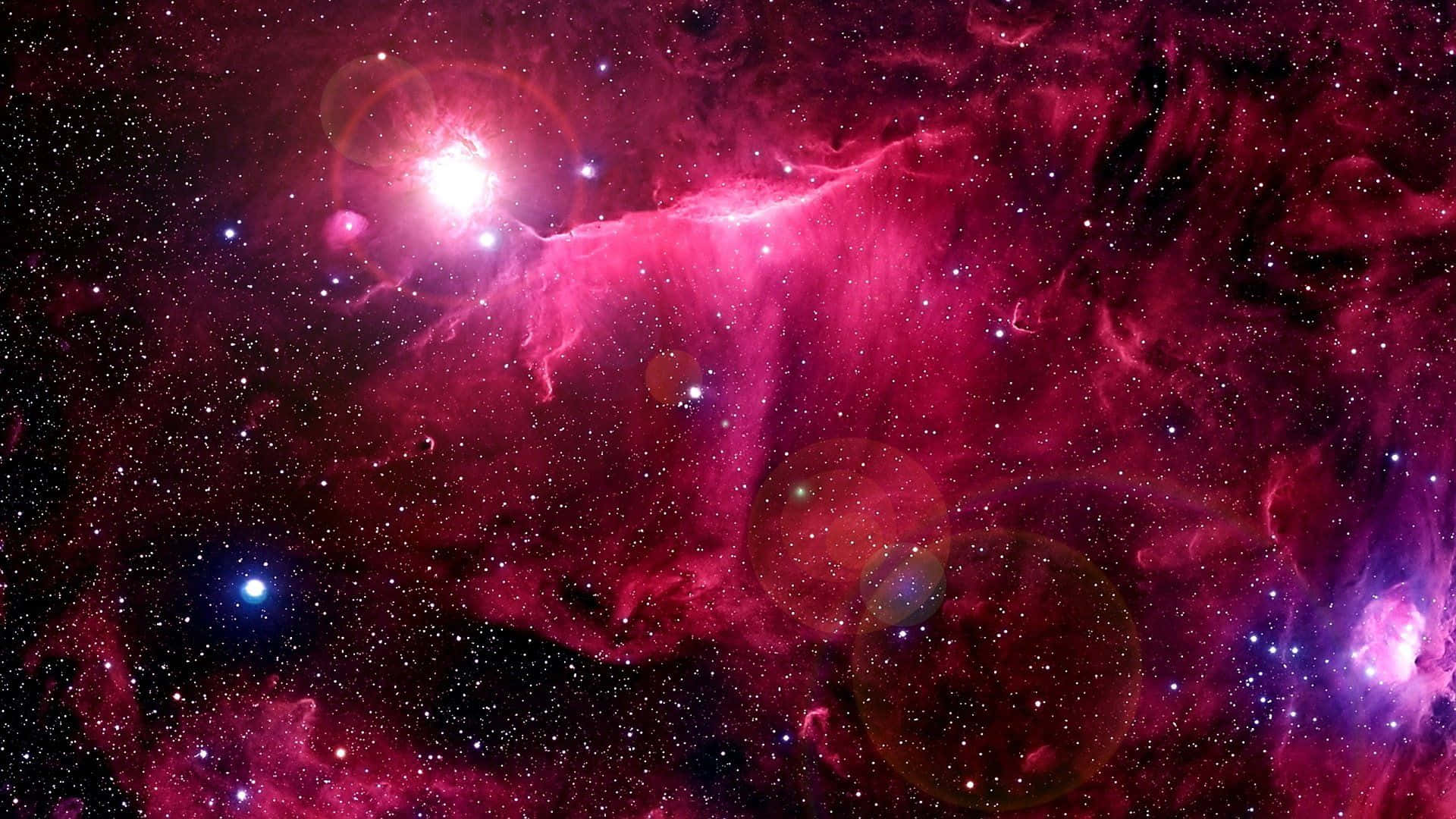 A Pink Nebula With Stars And Stars Wallpaper