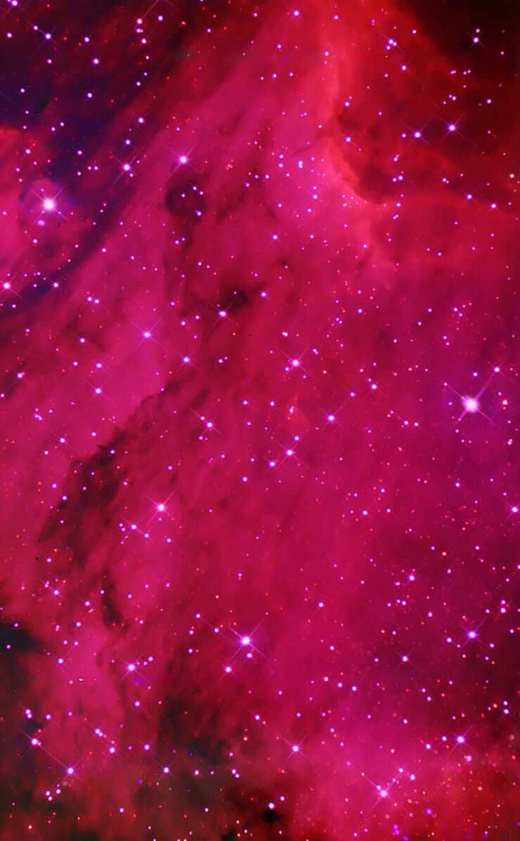 A Pink Nebula With Stars And Stars Wallpaper