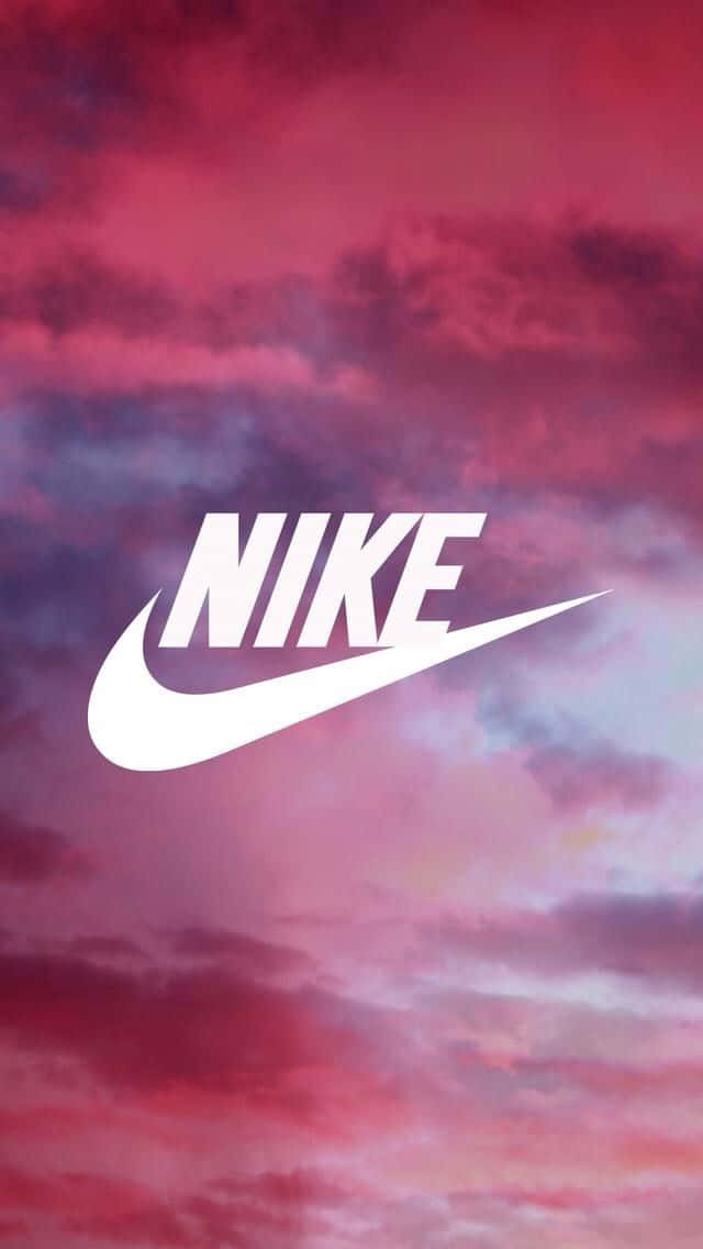 Nike Logo On A Pink Sky With Clouds Wallpaper