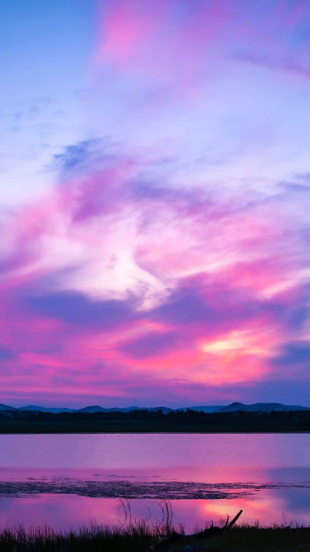 "Take in the Beauty of a Pink Sunset through Your Iphone" Wallpaper