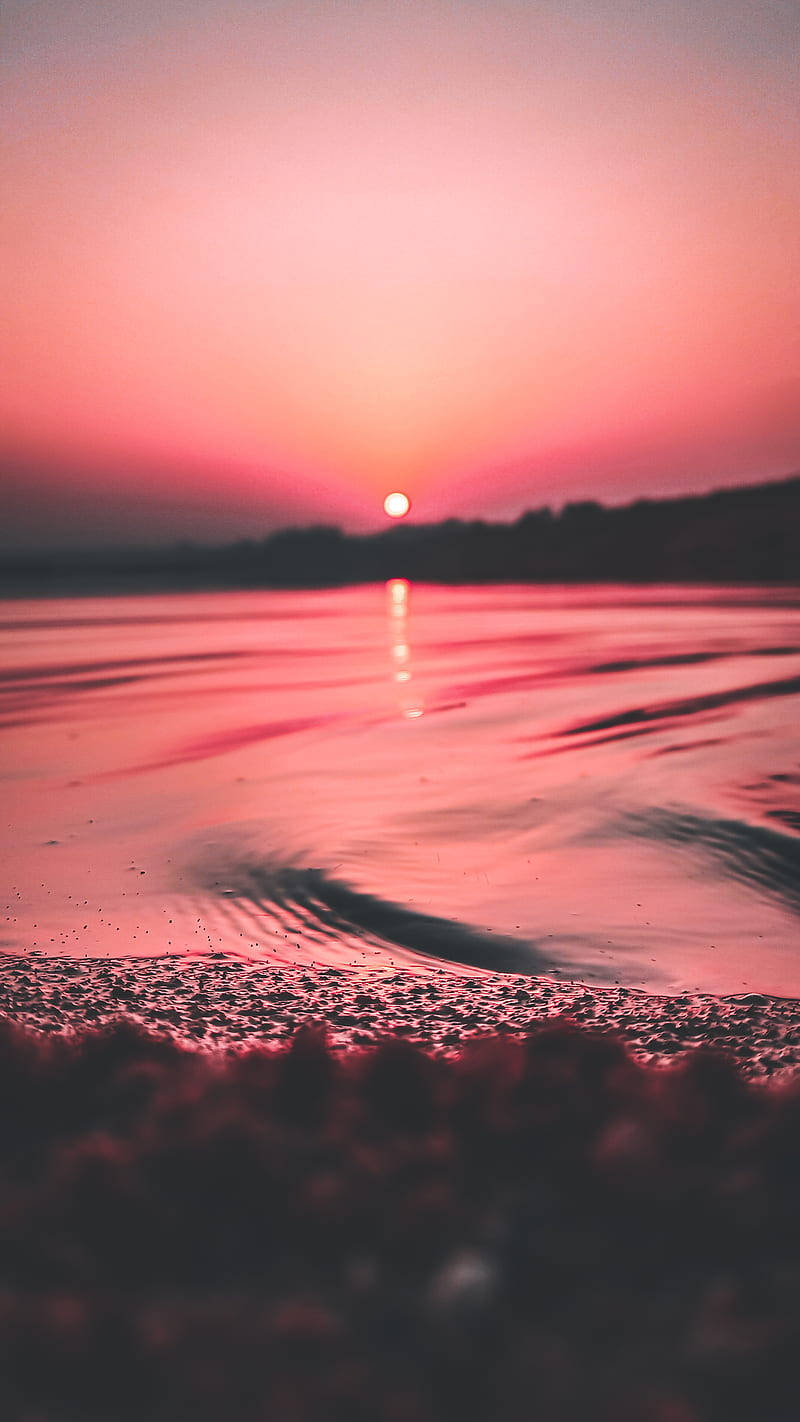 Soak in the beauty of a pink and orange sunset with your iPhone Wallpaper