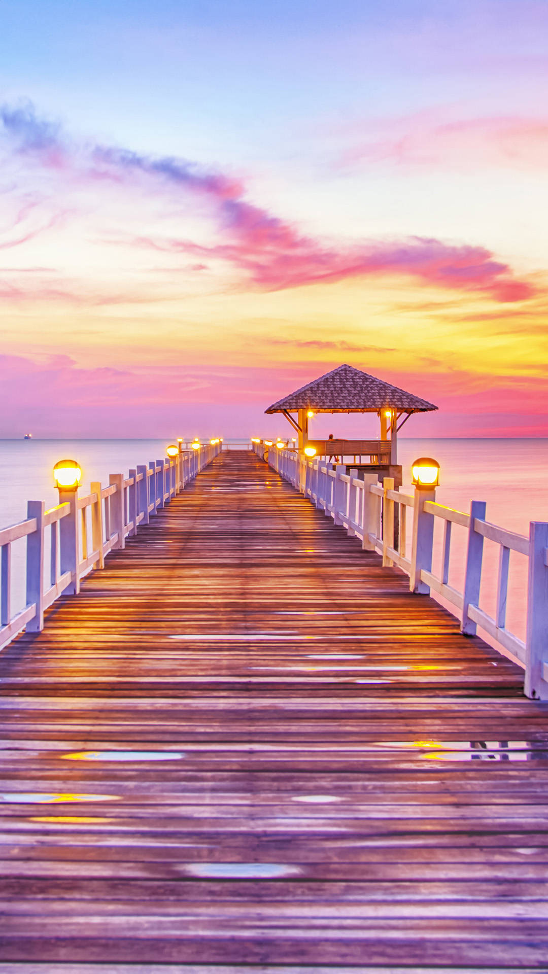 A Wooden Pier With A Sunset View Wallpaper