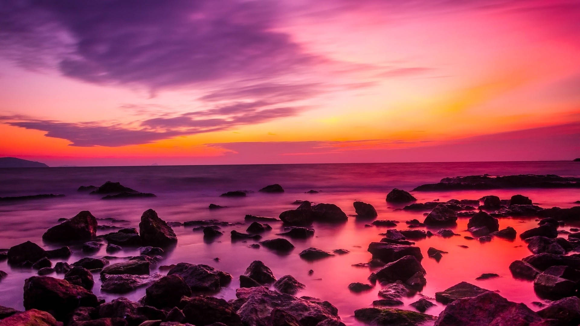 Pink Sunset On Rocky Beach Wallpaper