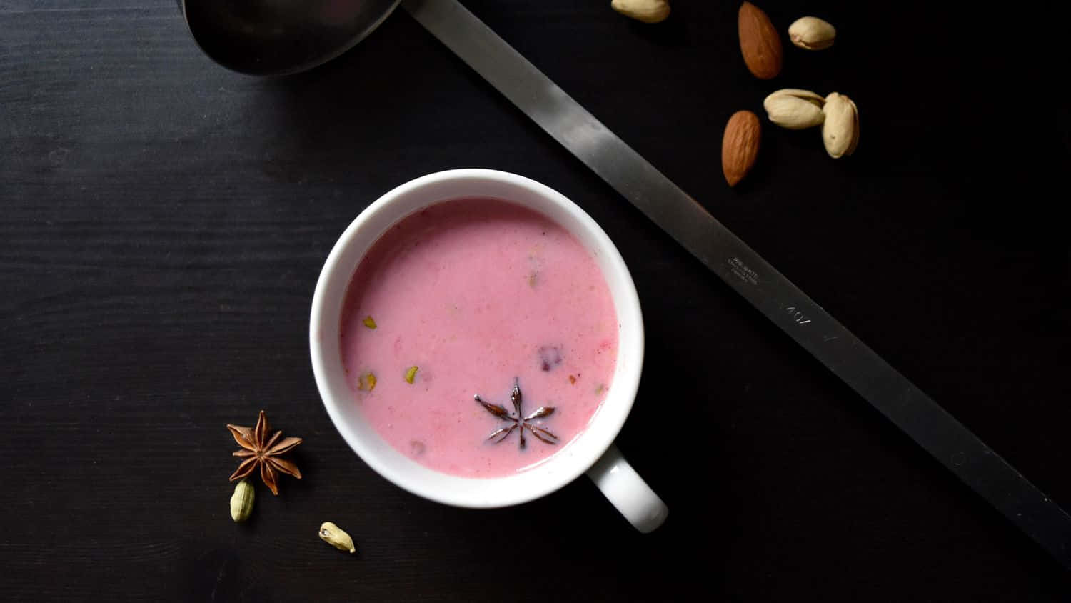 Elegant Pink Tea in a Delicate Glass Cup Wallpaper