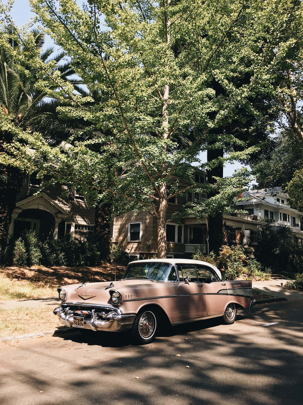 A Classic Car Parked In Front Of A House Wallpaper