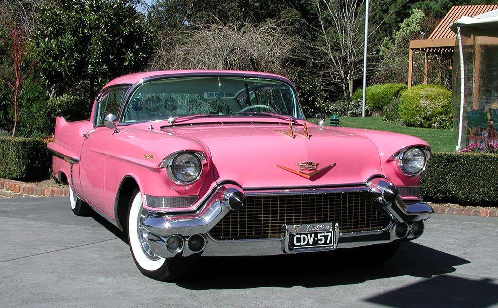 Take a ride in this gorgeous pink vintage car Wallpaper