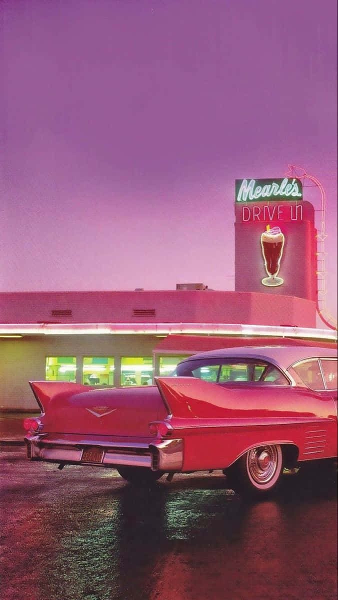 A Pink Car Is Parked In Front Of A Diner Wallpaper