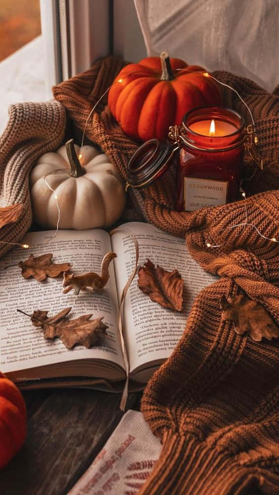 Autumn Leaves, Pumpkins, Candle And Book On A Window Sill Wallpaper