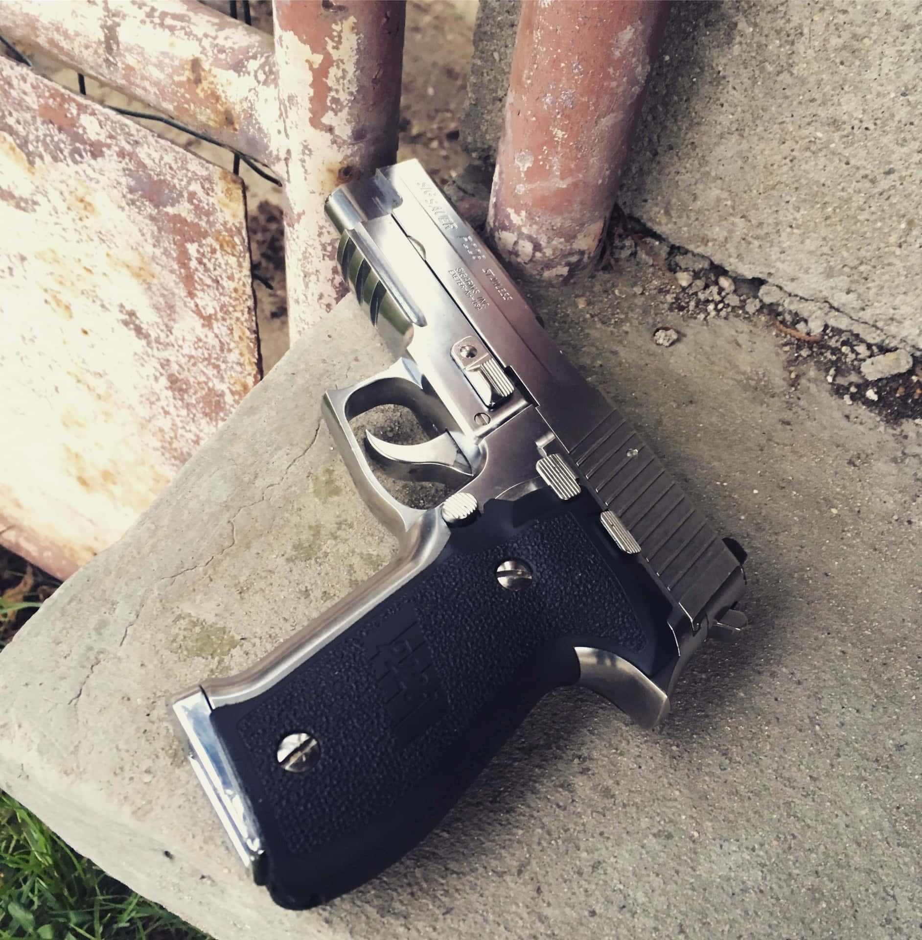 Pistol Placed Down A Concrete Surface Picture