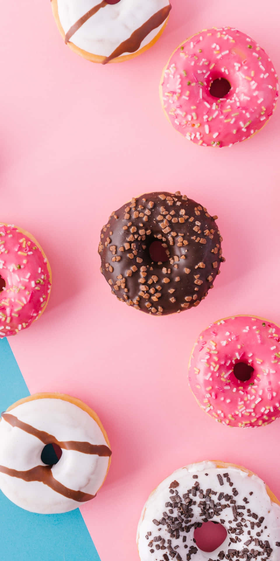 A Group Of Donuts On A Pink And Blue Background