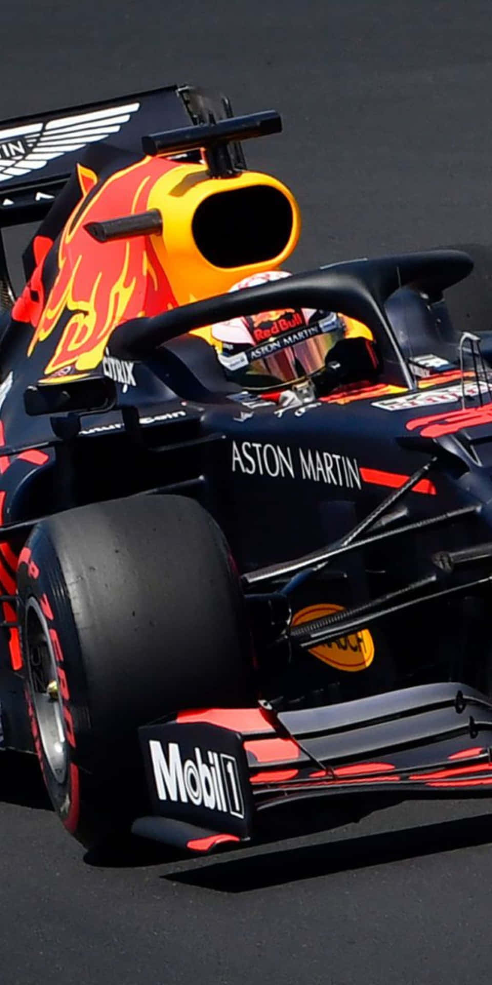 A Red Bull Racing Car Is Driving On A Track