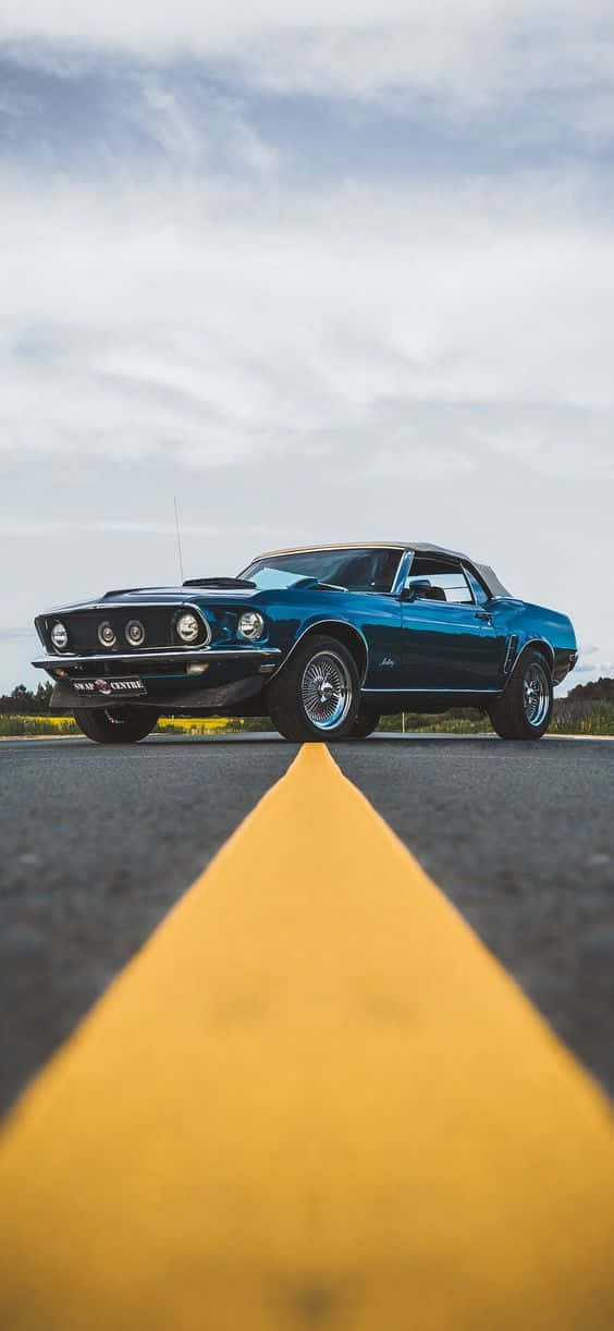 A Blue Mustang Parked On The Road