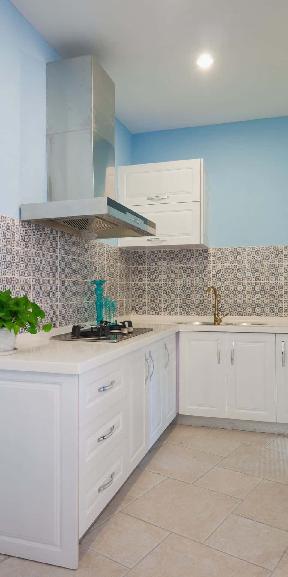 A White Kitchen With Blue Walls And Tile Floors