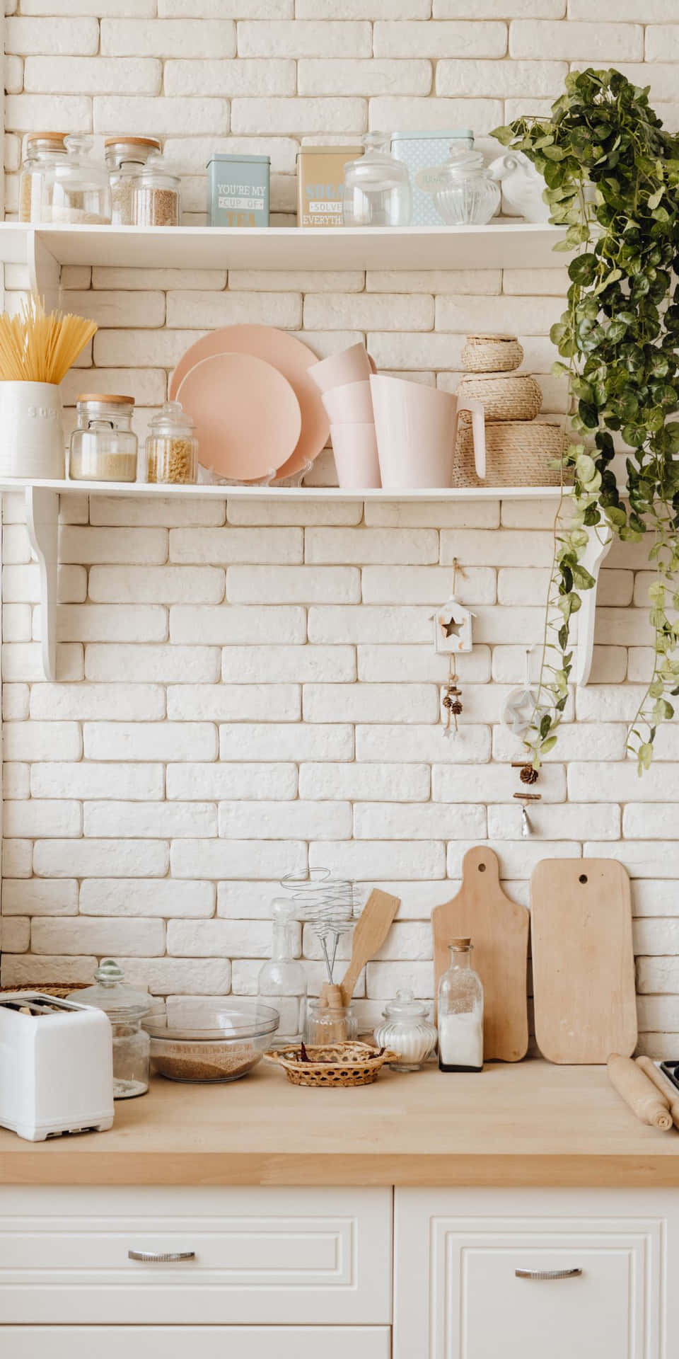 A Kitchen With A White Brick Wall And Shelves