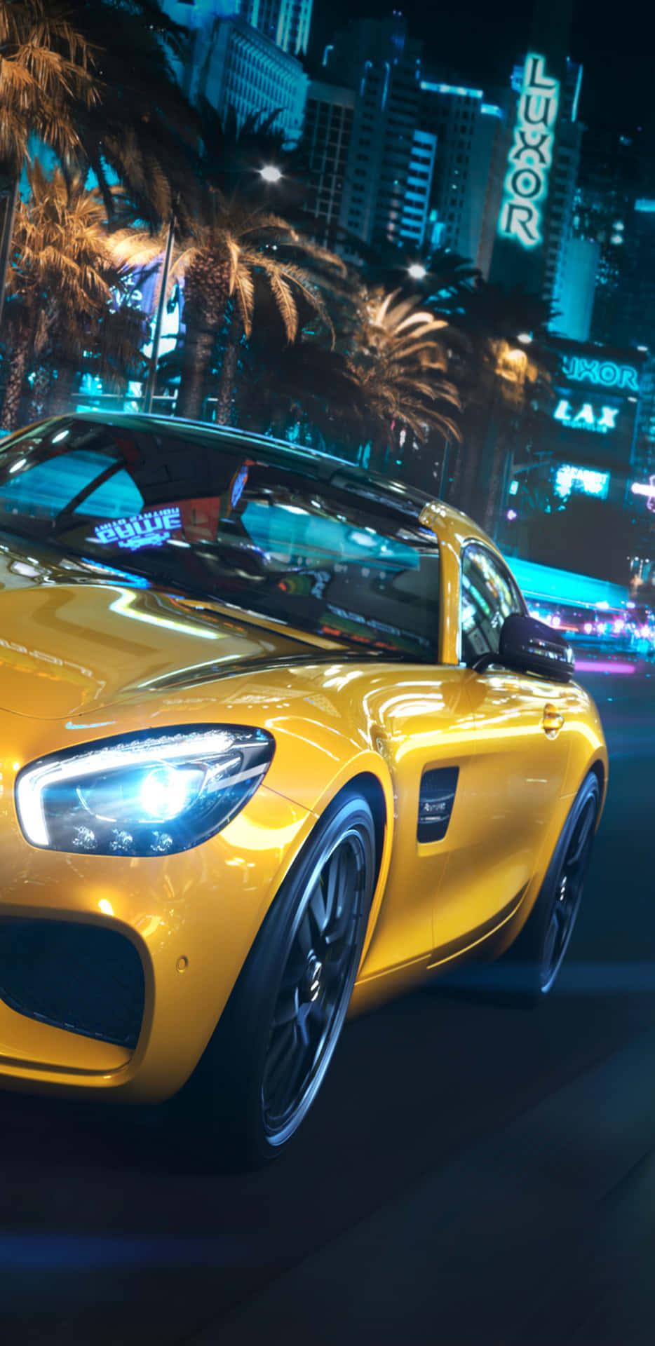 A Yellow Sports Car Driving Down The Street At Night