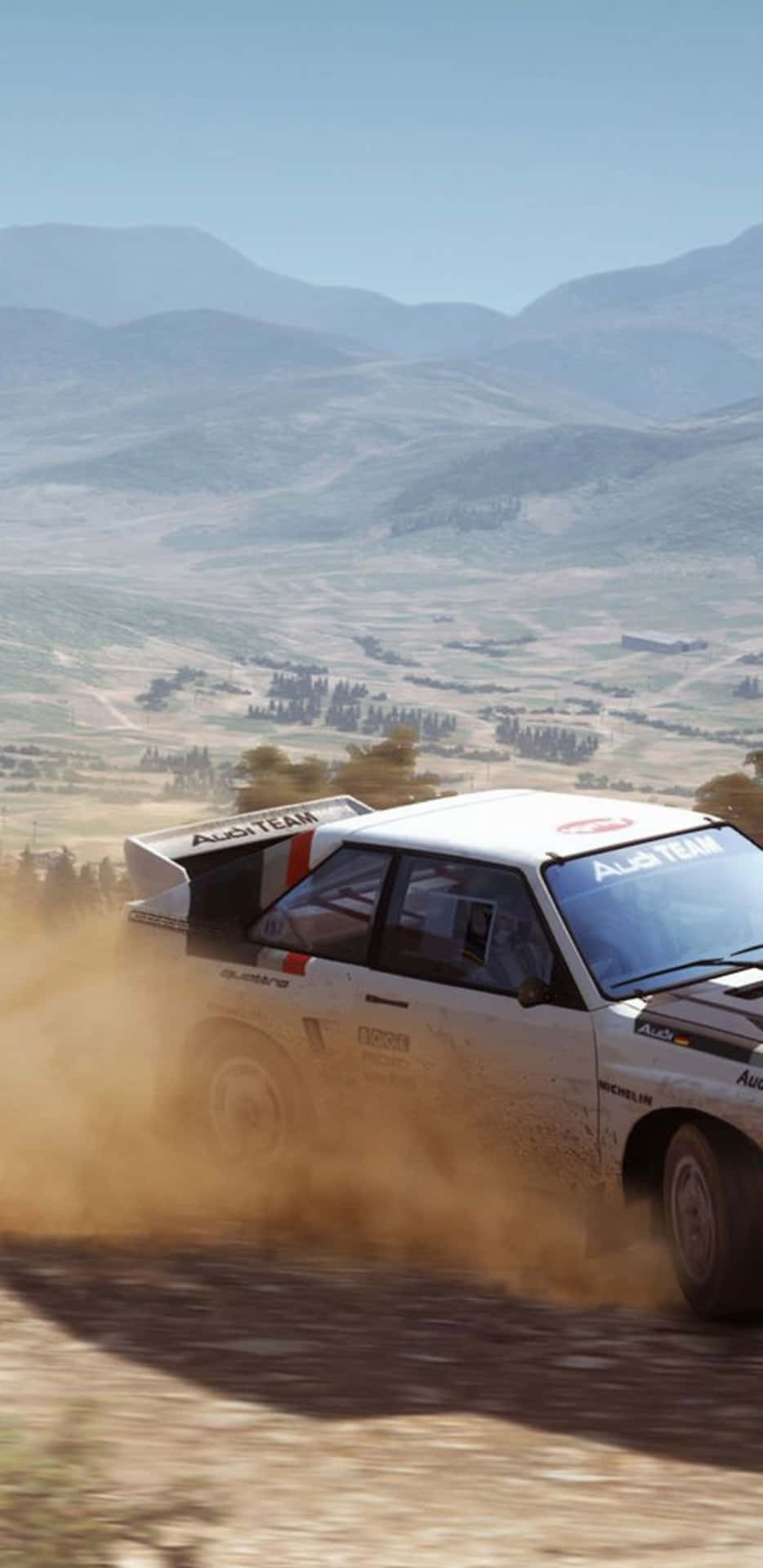 A Rally Car Driving Through A Dirt Road