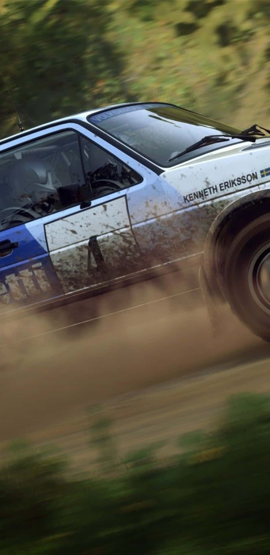 A Rally Car Driving Down A Dirt Road
