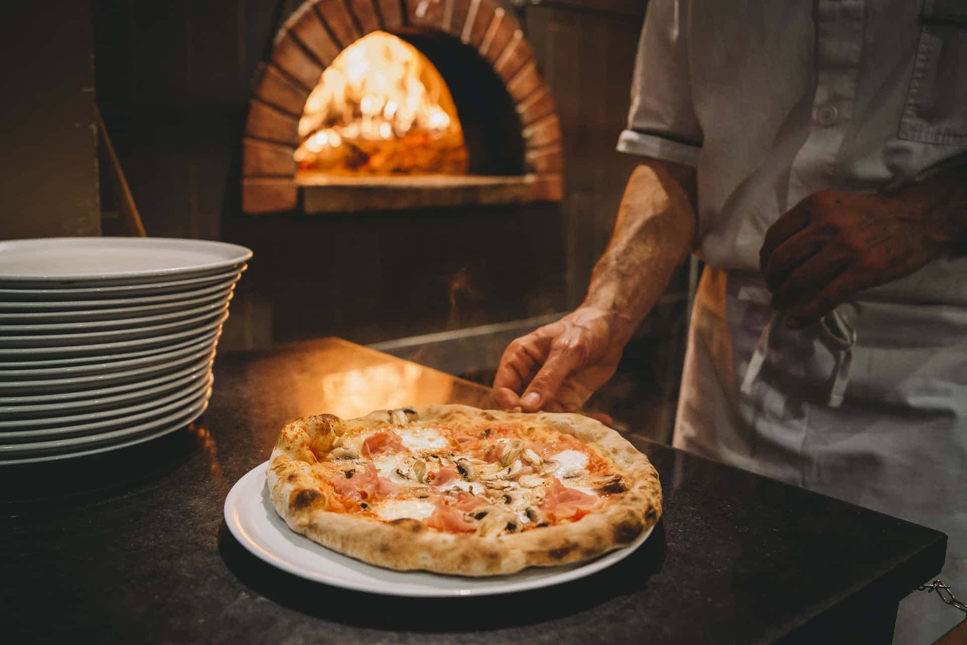 Pizza On White Plate Near Oven Picture
