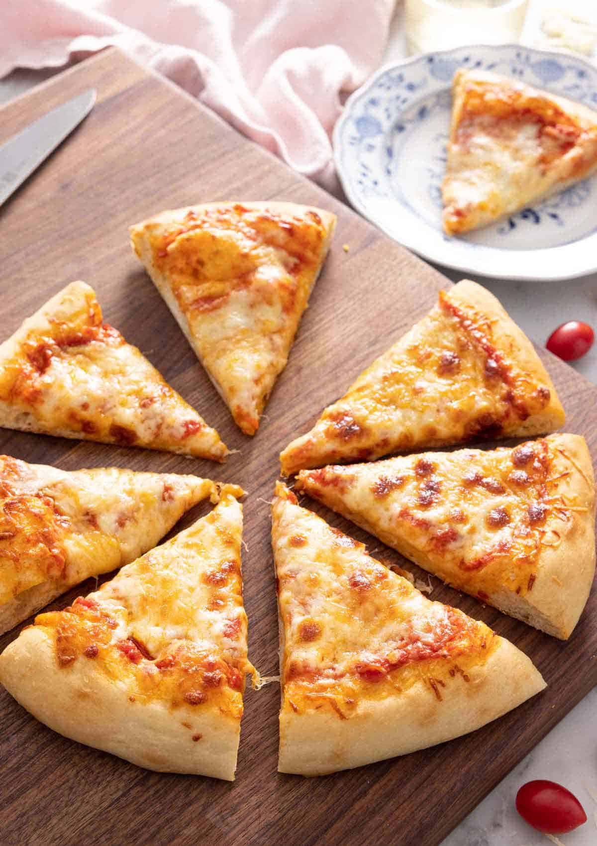 Pizza Slices On Chopping Board Picture