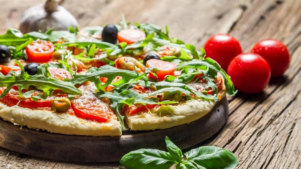 Pizza Topped With Arugula, Tomato, And Olive Wallpaper
