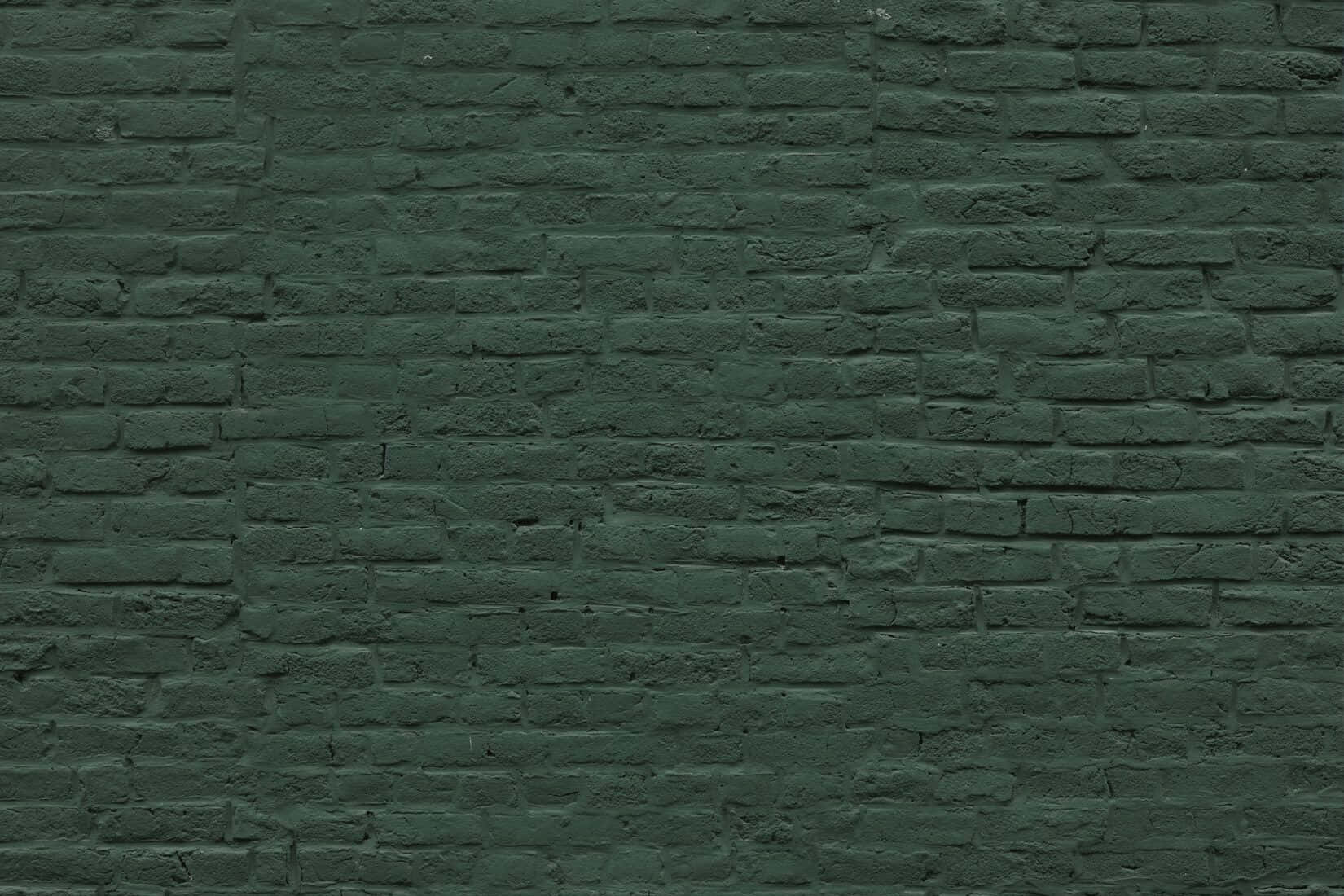 Enkelmörkgrön Murtegelvägg. Wallpaper