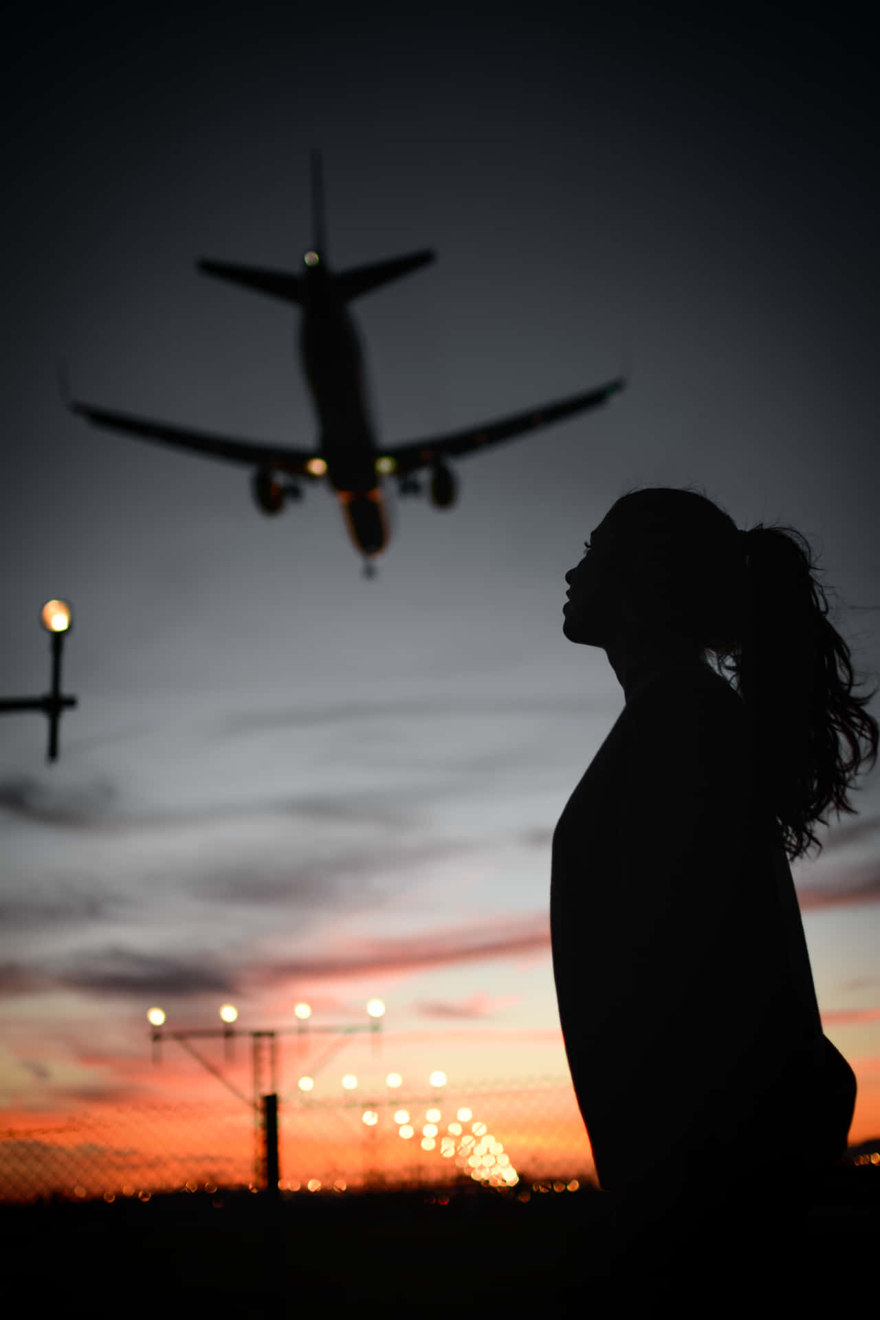 A Woman Is Standing In Front Of A Plane Wallpaper