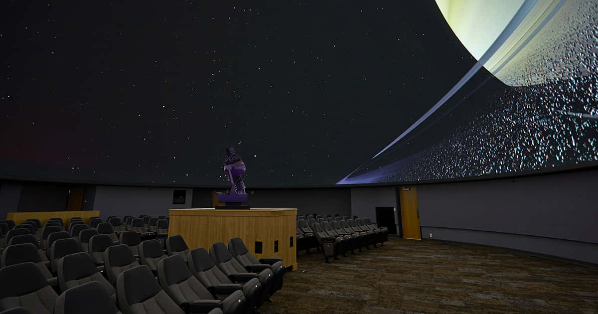 A Stunning View of the Night Sky in a Planetarium Wallpaper