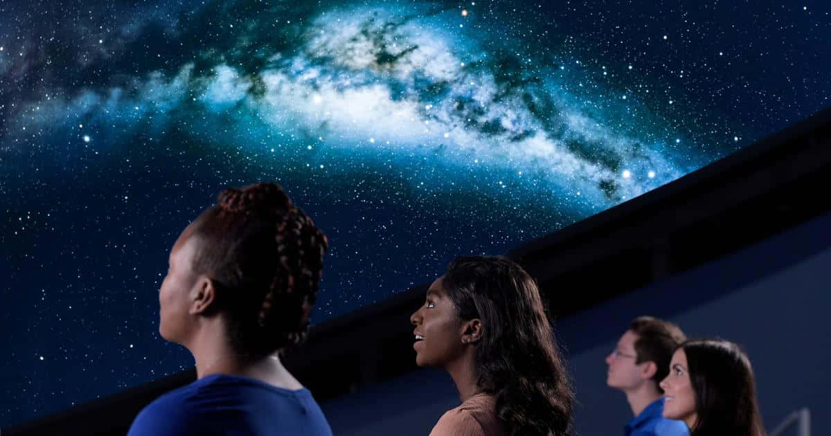 A captivating glimpse into the cosmos at the Planetarium Wallpaper