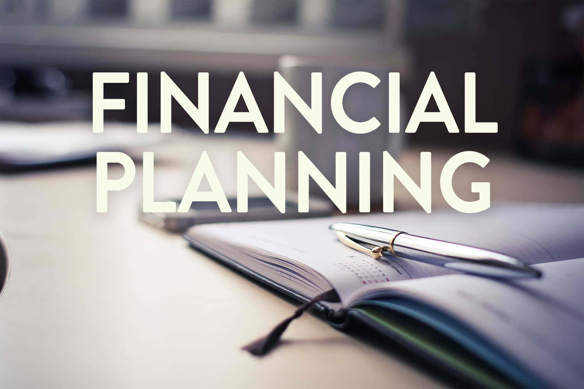 Financial Planning - A Notebook And Pen On A Desk