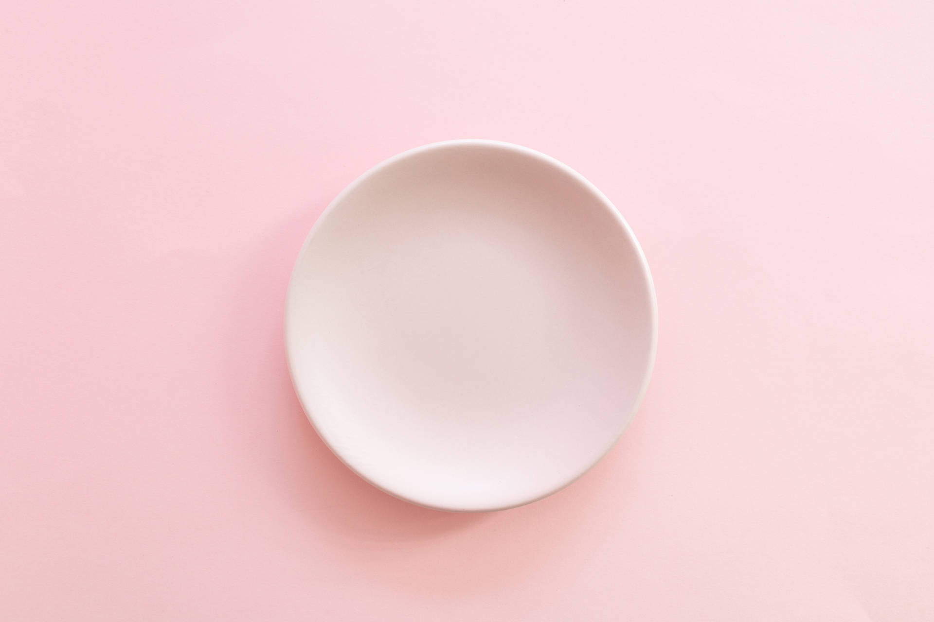 Plate On Pastel Pink Color Background Wallpaper