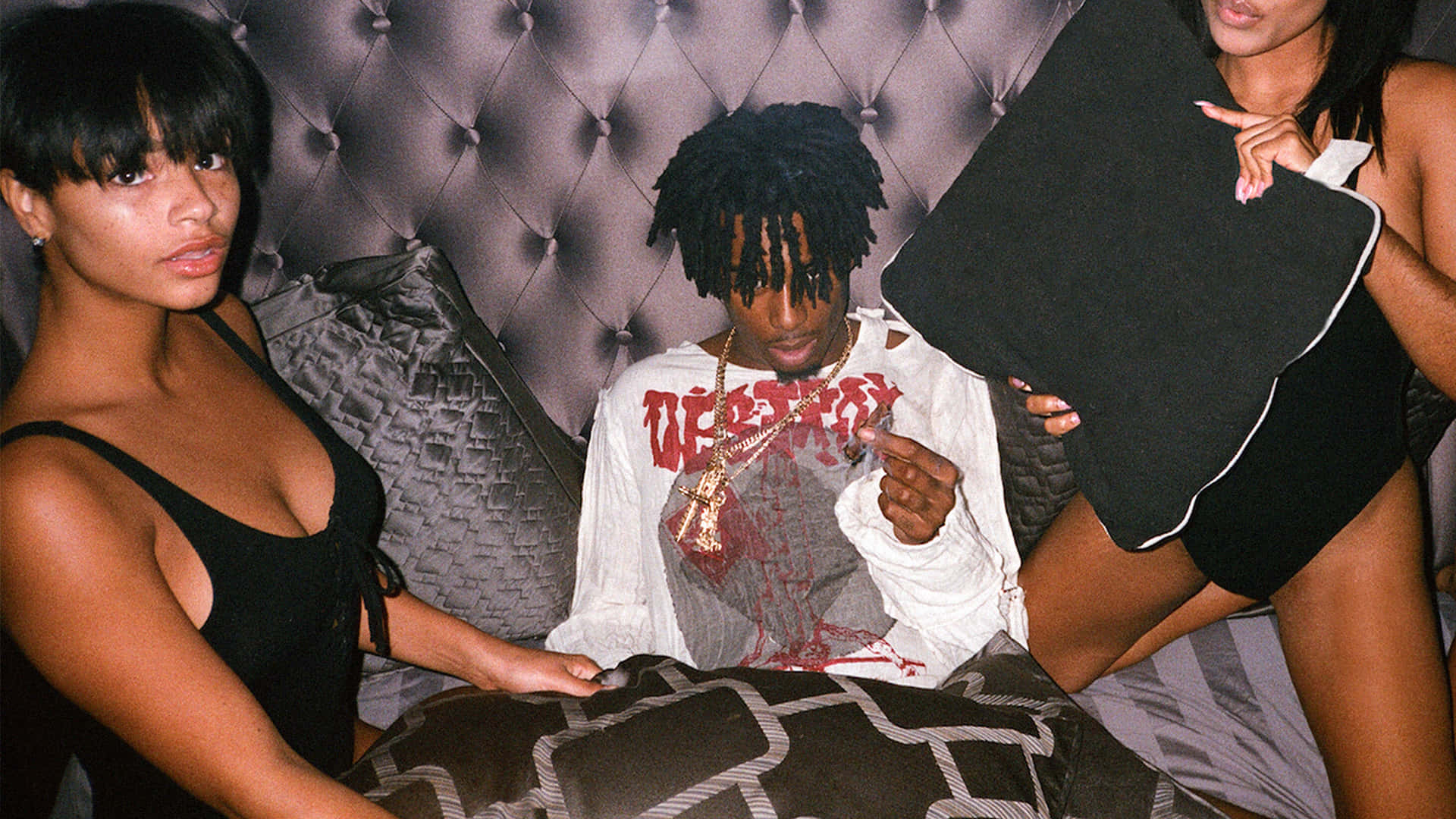 Playboi Carti, an American rapper and songwriter, dressed in a signature red and black plaid flannel shirt. Wallpaper