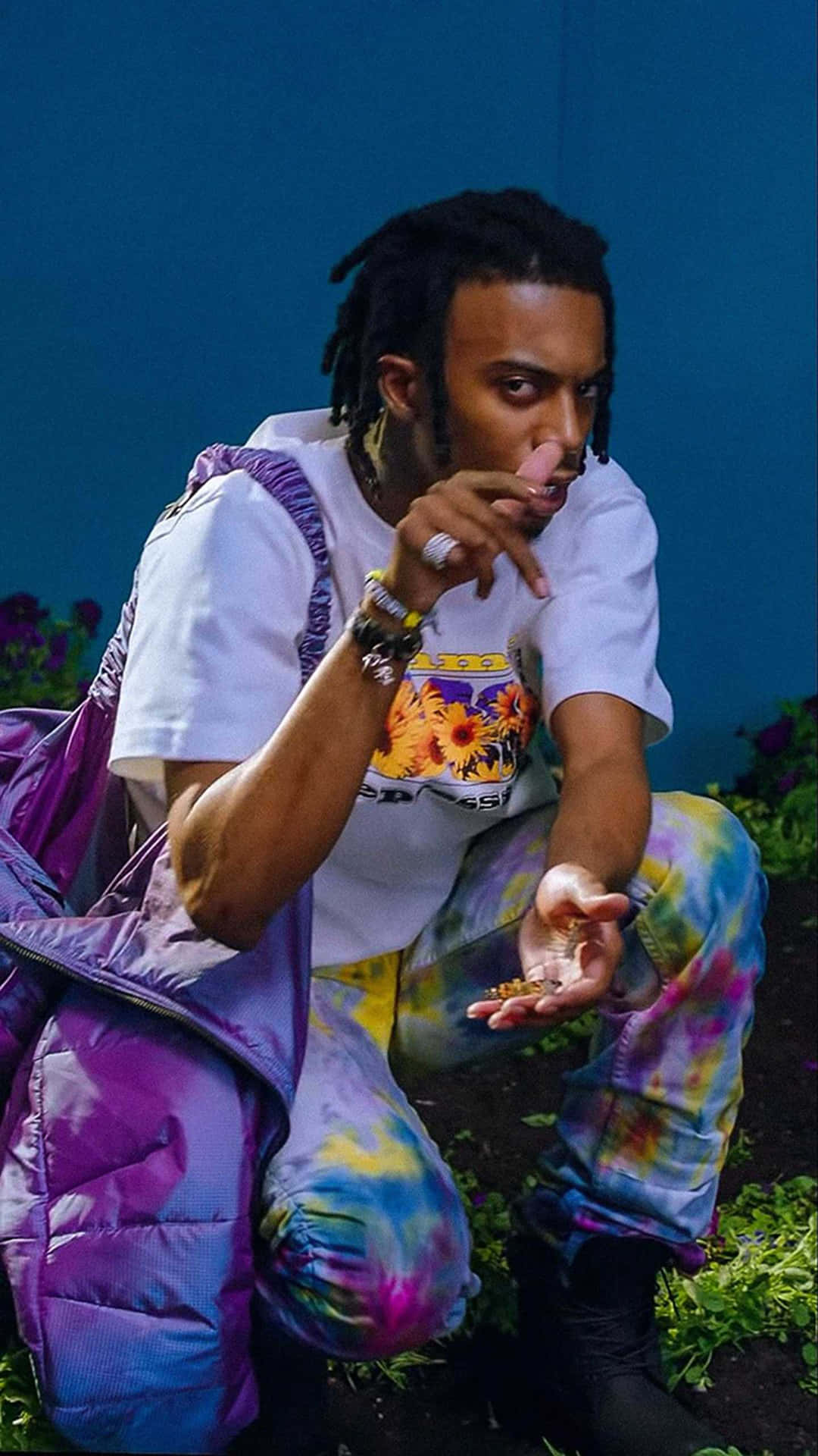 A Man With Dreadlocks And A Purple Backpack Wallpaper