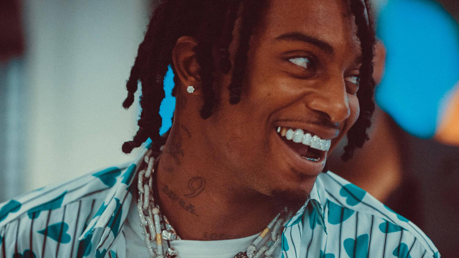 Playboi Carti Smiling Widely Background