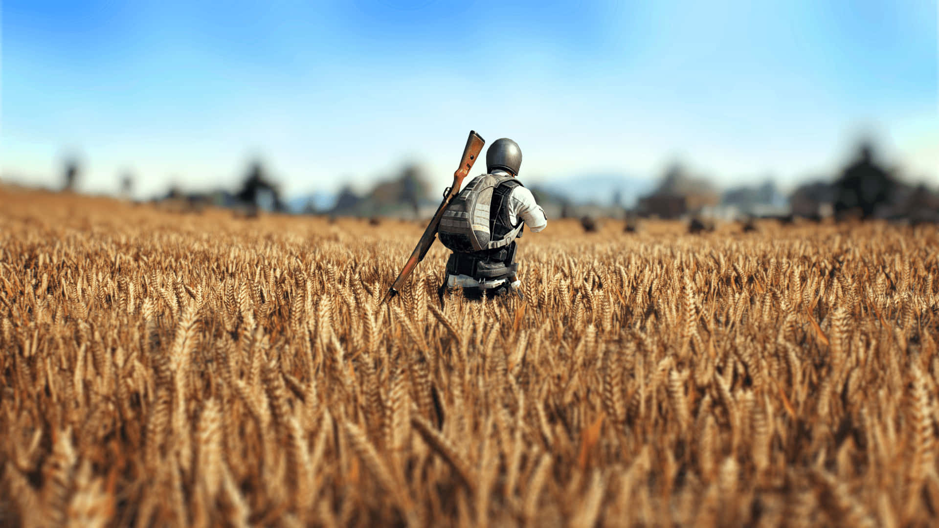 A Man Walking Through A Field With A Rifle Wallpaper