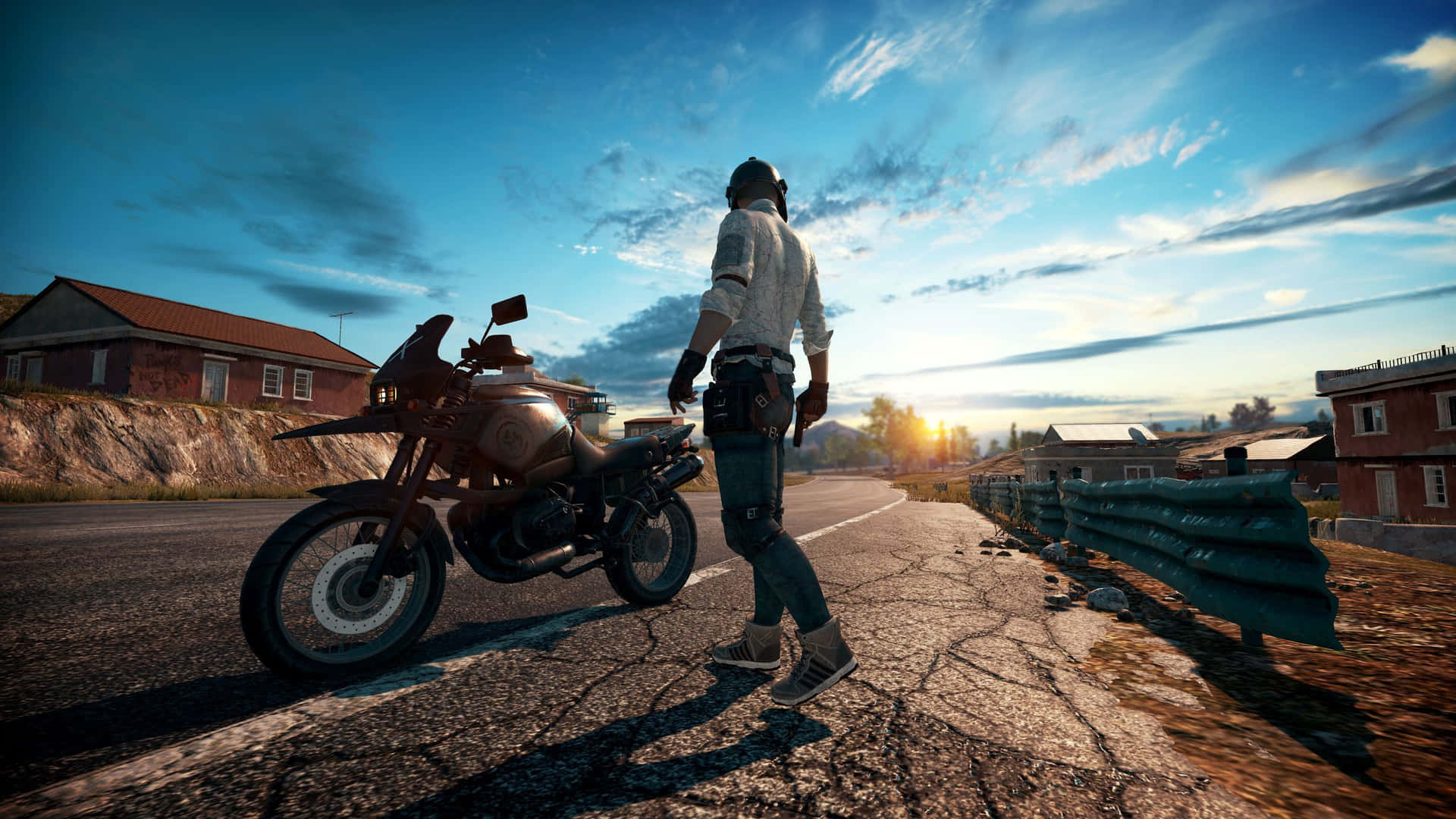 En mand står på en vej med en motorcykel. Wallpaper
