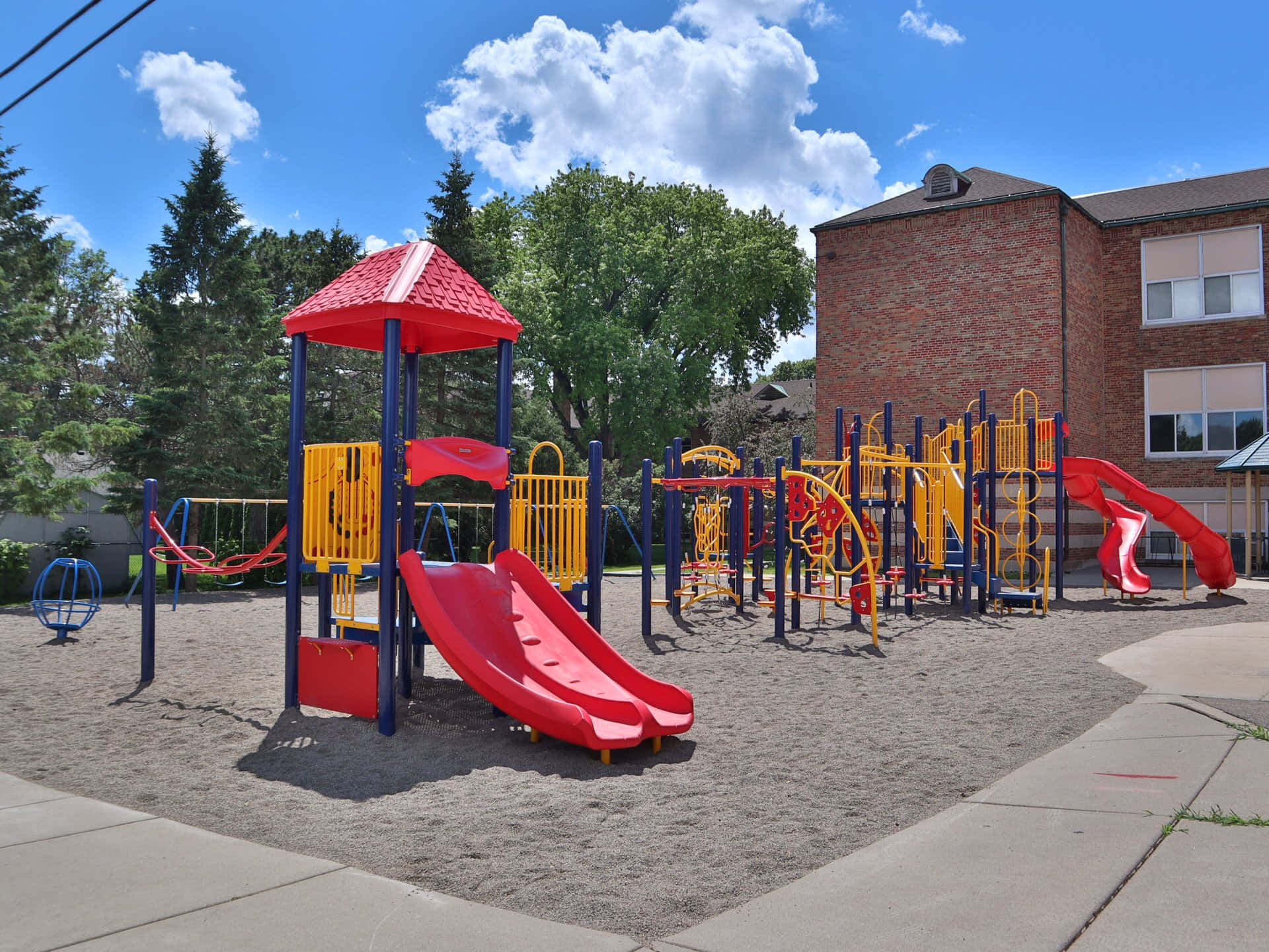 Children playing in a park with various playground equipment