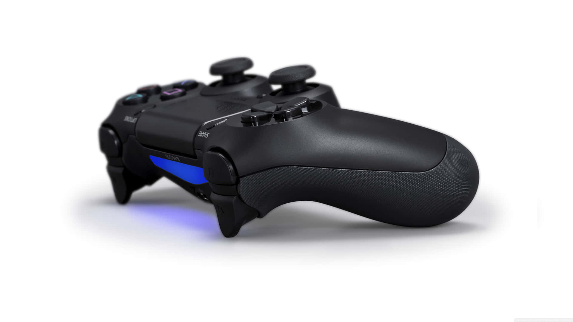 A Black Playstation Controller With Blue Lights Wallpaper