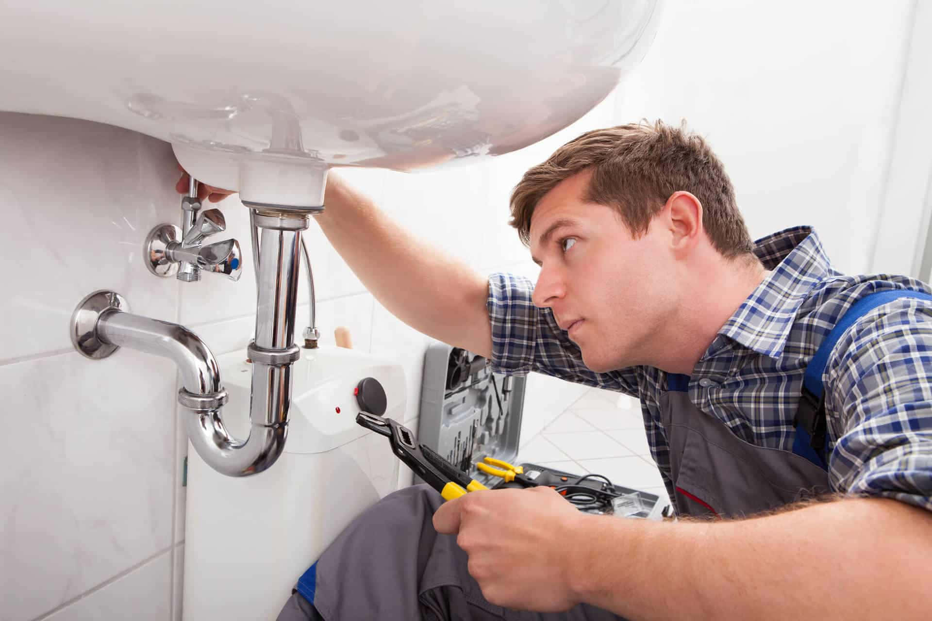 Professional Plumber Fixing a Pipe