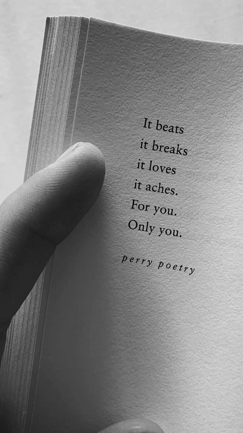 A Person Holding A Book With The Words If Beats It Breaks It Loves You Only You Wallpaper