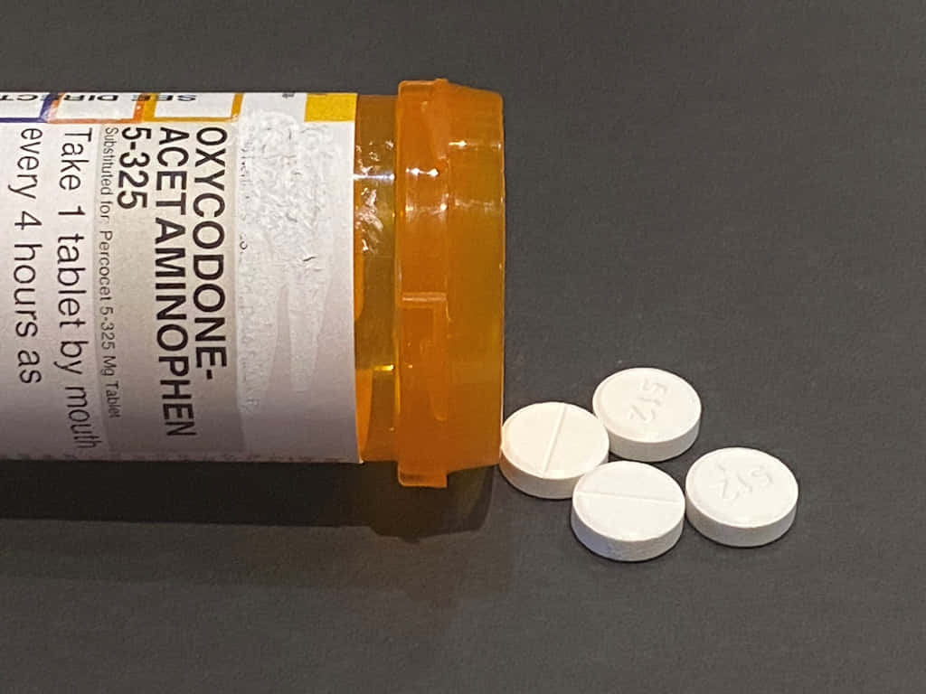 A Bottle Of Oxycodone Pills On A Table