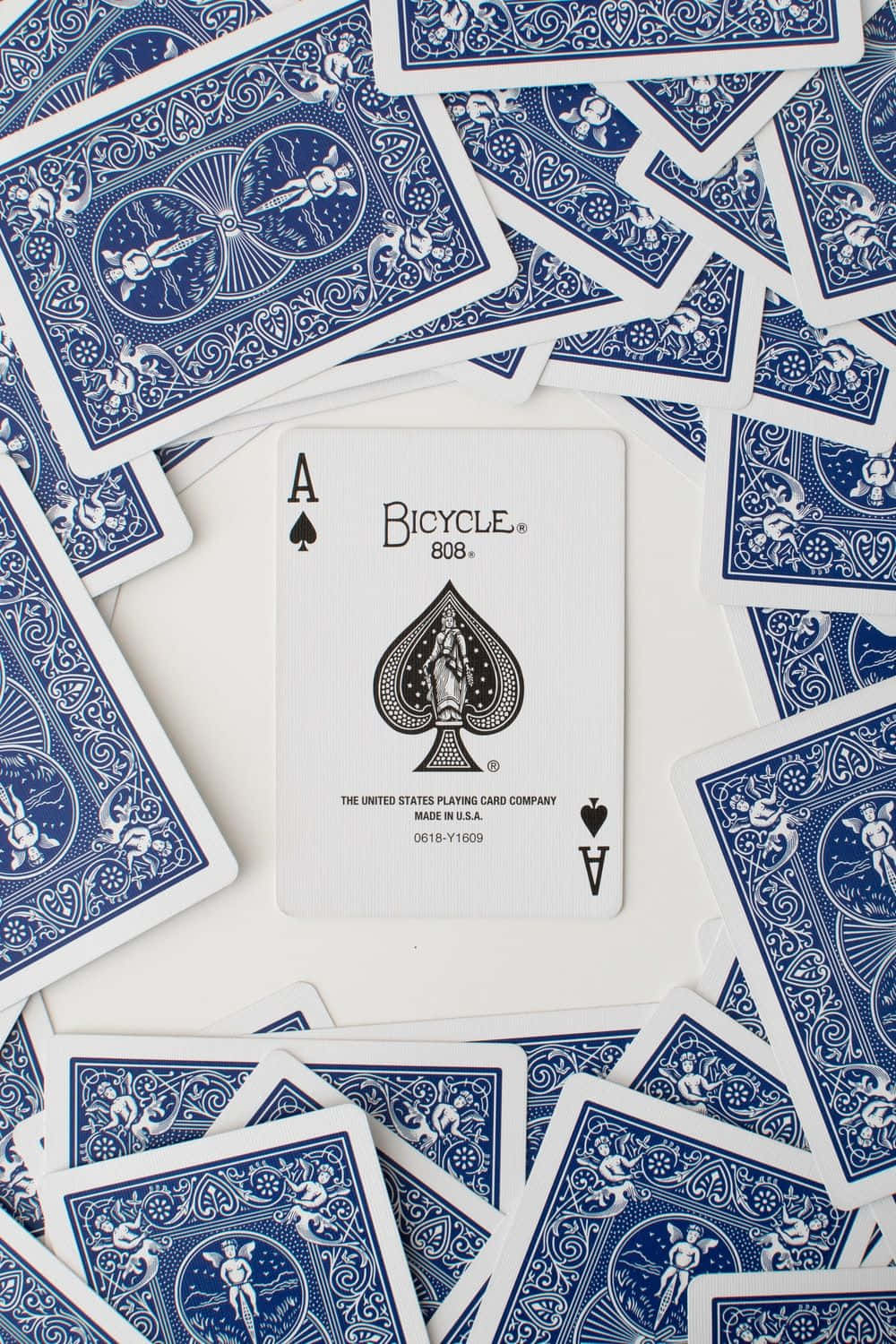 A Pile Of Blue Playing Cards On A White Surface