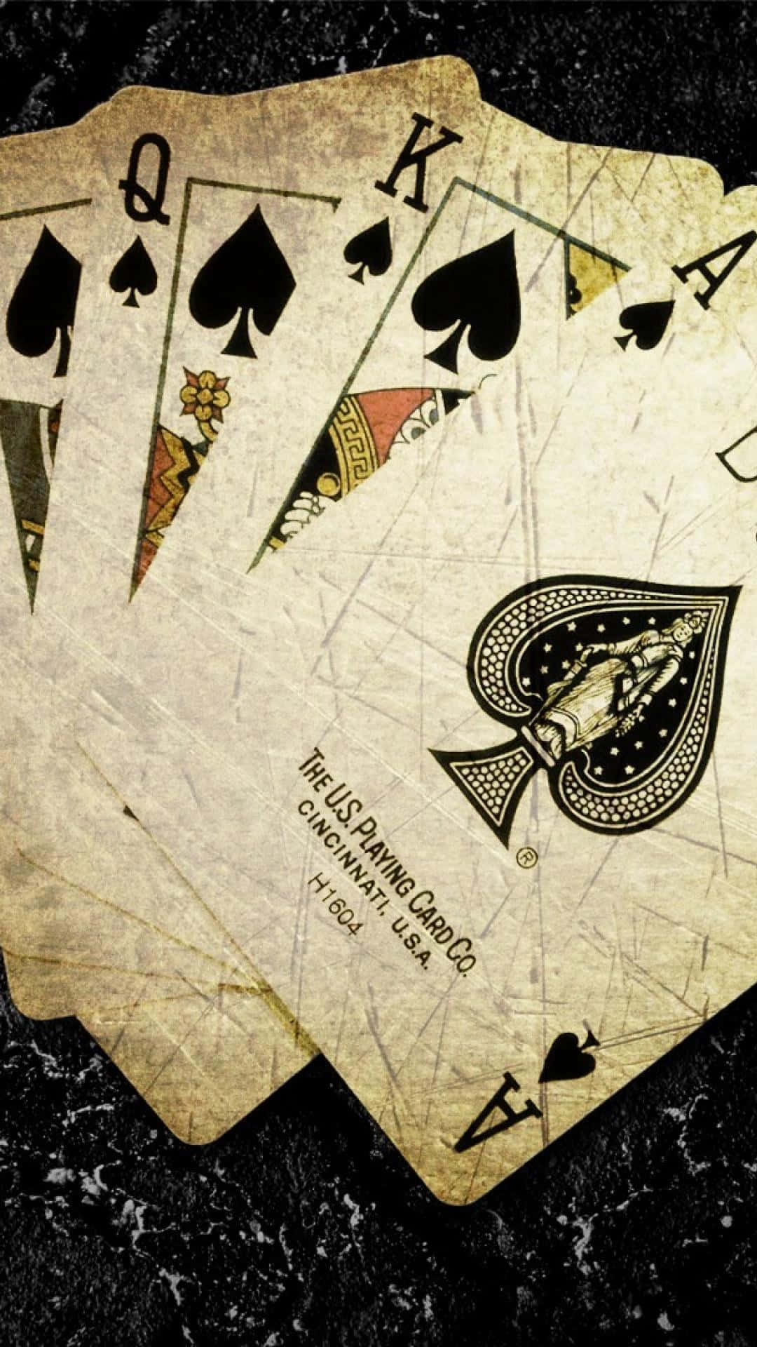 A Set Of Playing Cards On A Black Surface