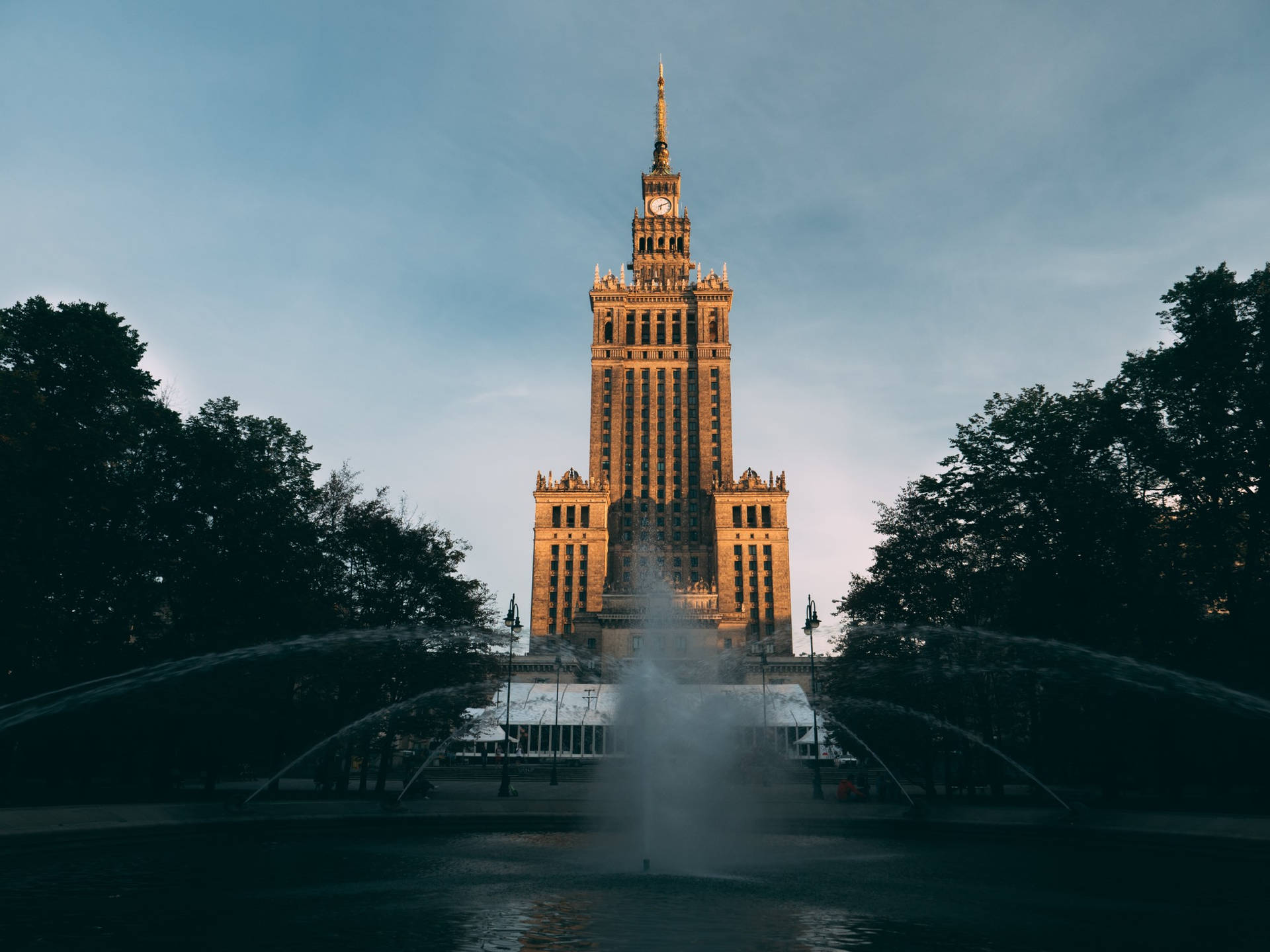 Majestic Poland's Palace of Culture Against Blue Sky Wallpaper