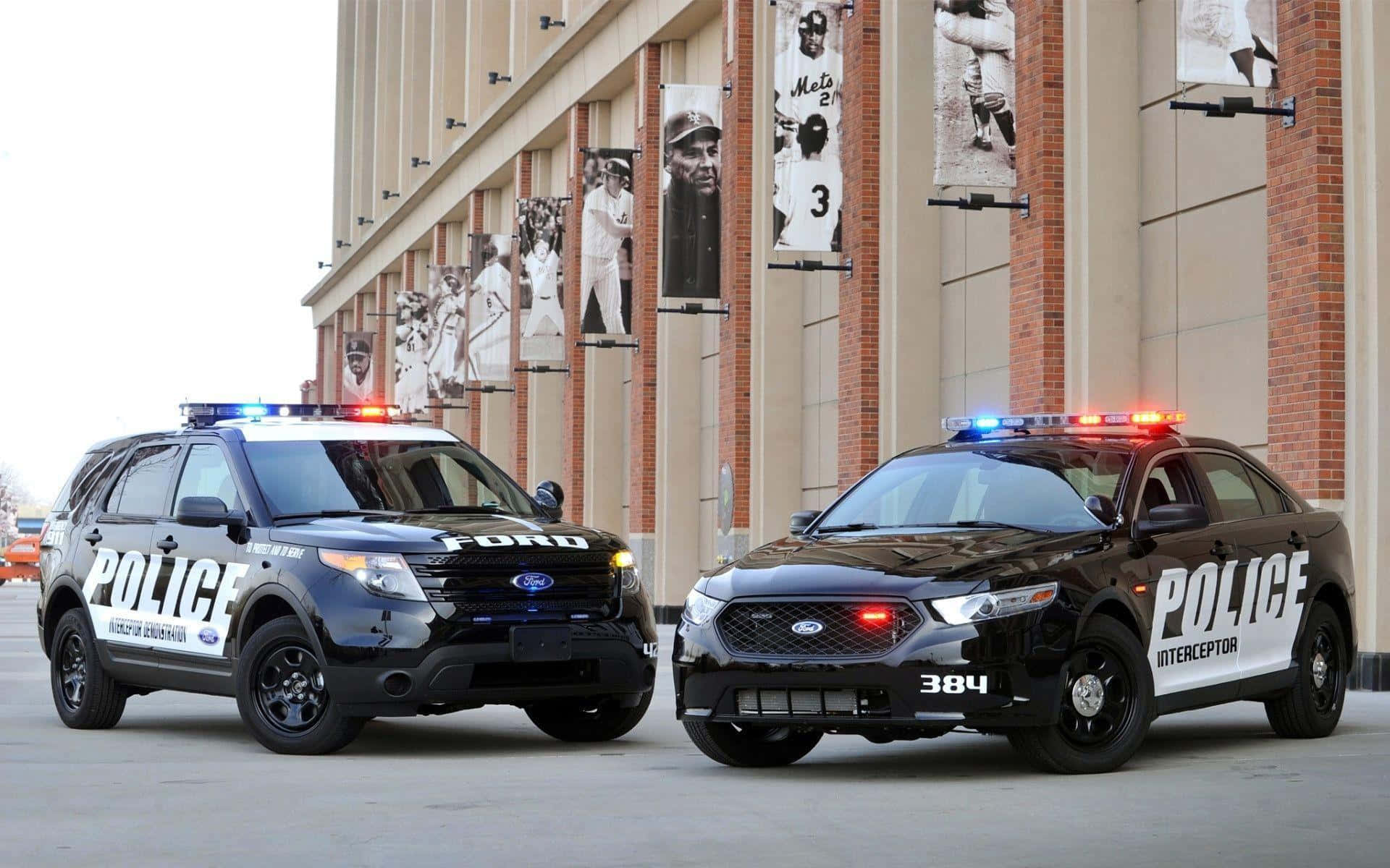 Two Police Vehicles Parked In Front Of A Building